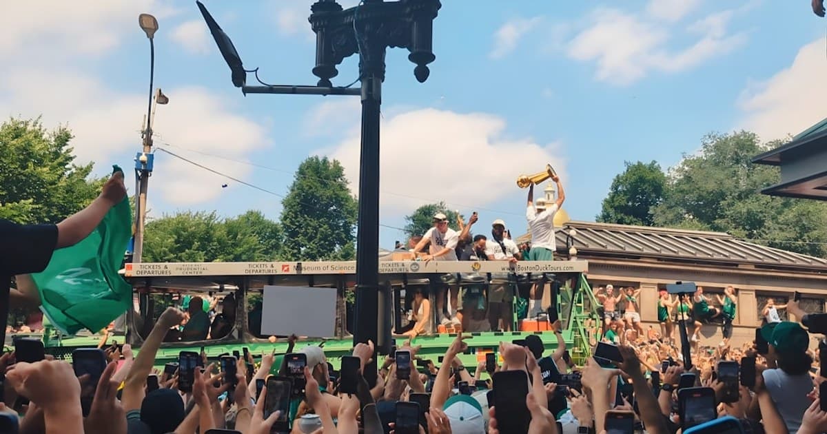 Jayson Tatum with the Larry O'Brien Trophy in front of passionate fans at the Celtics Championship Parade on Friday, June 21, 2024.