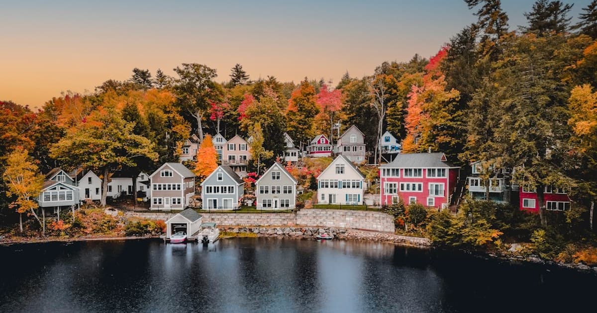 An aerial view of homes on Lake Winnepesauke, New Hampshire during peak foliage season.