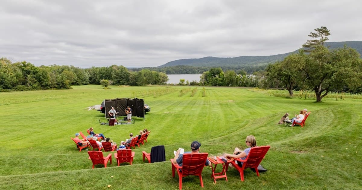 red and white chairs on green grass field during daytime