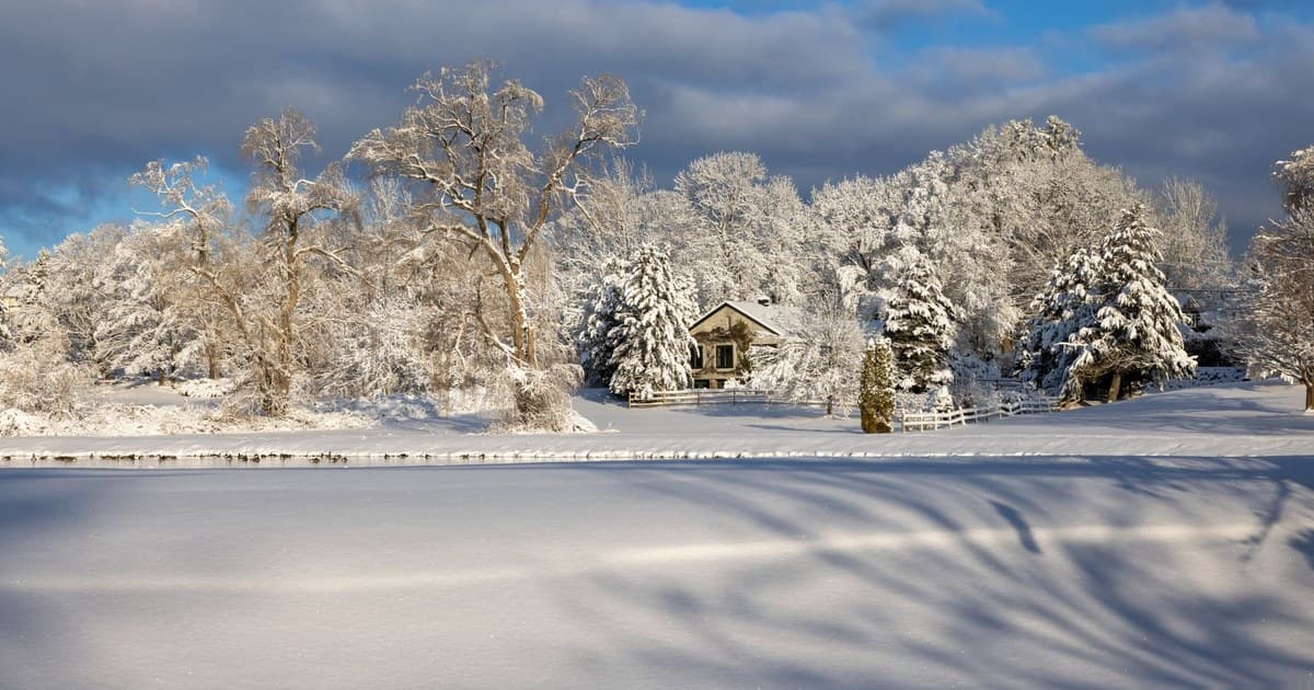 Snow-covered landscape with a house in Southborough, MA creating a serene winter scene.